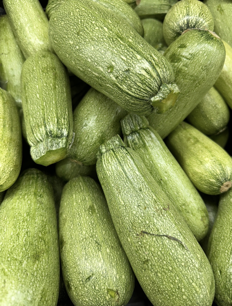 A detailed close-up of fresh organic zucchinis, showcasing their vibrant green color and texture.