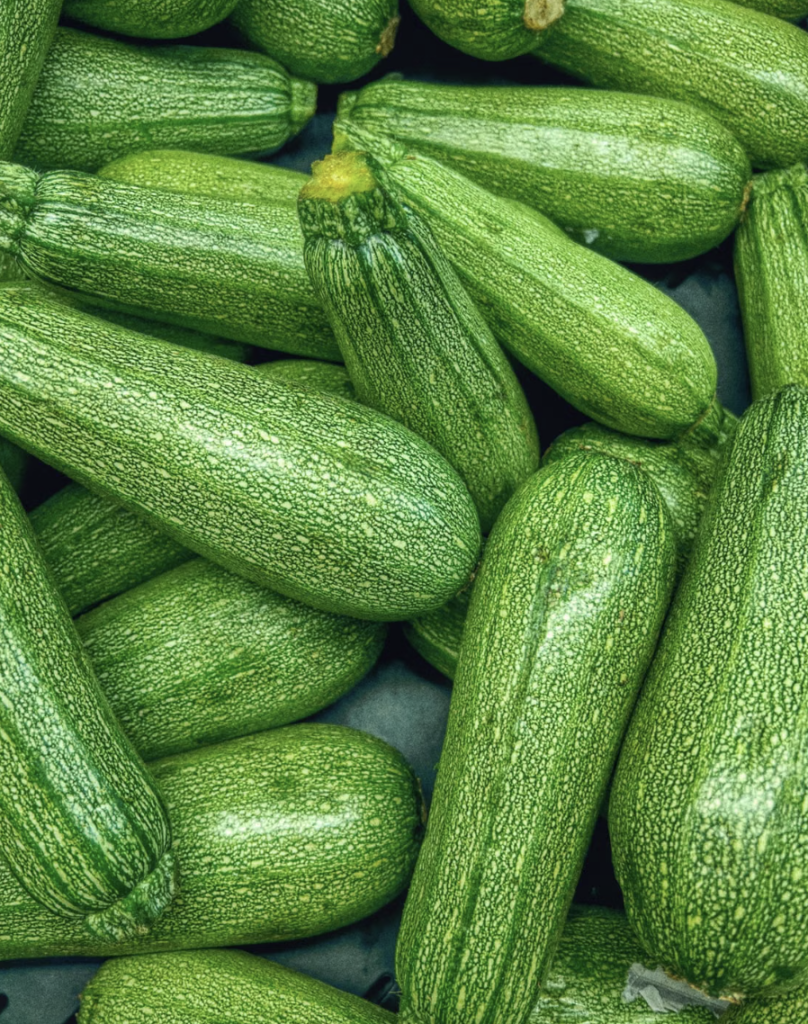 Vibrant close-up of fresh green zucchinis showcasing texture and color.